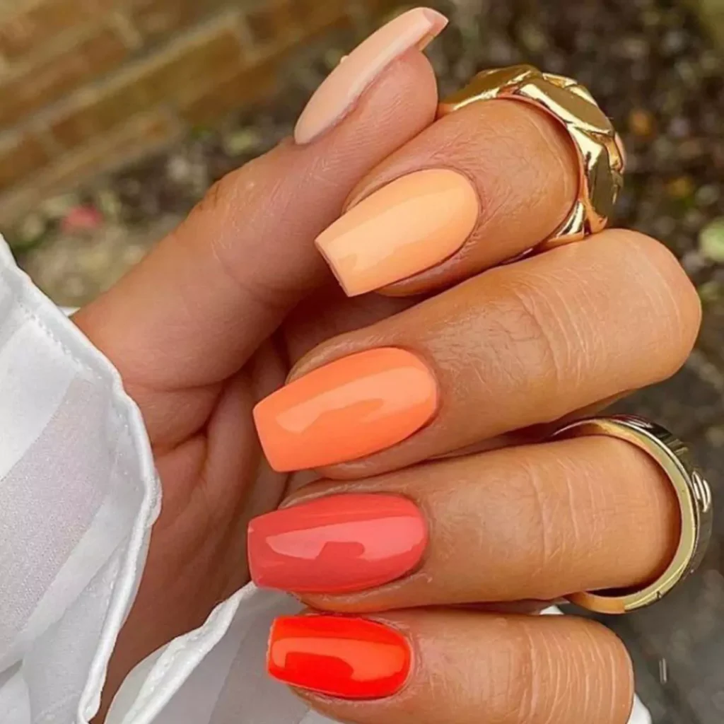 sparkling nail designs with an orange theme 