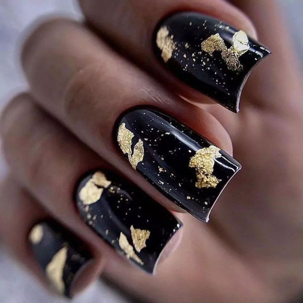 sophisticated black and gold nail designs of 2024