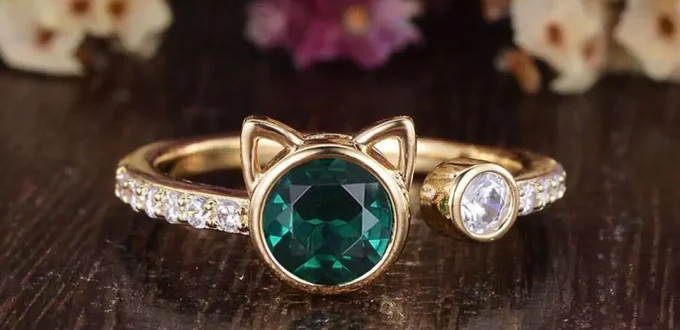 gem-stoned gold rings with cat designs