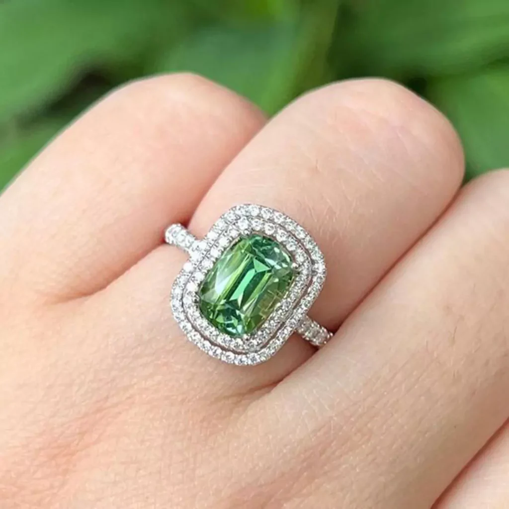 valuable gold rings with square green gemstones 