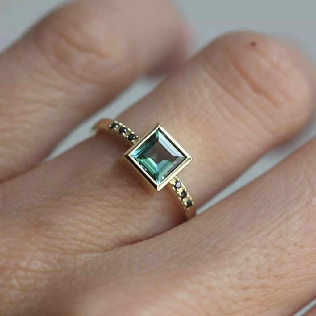 luxurious gold rings with square green gemstones 