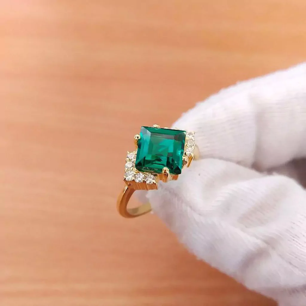 glamorous gold rings with square green gemstones 