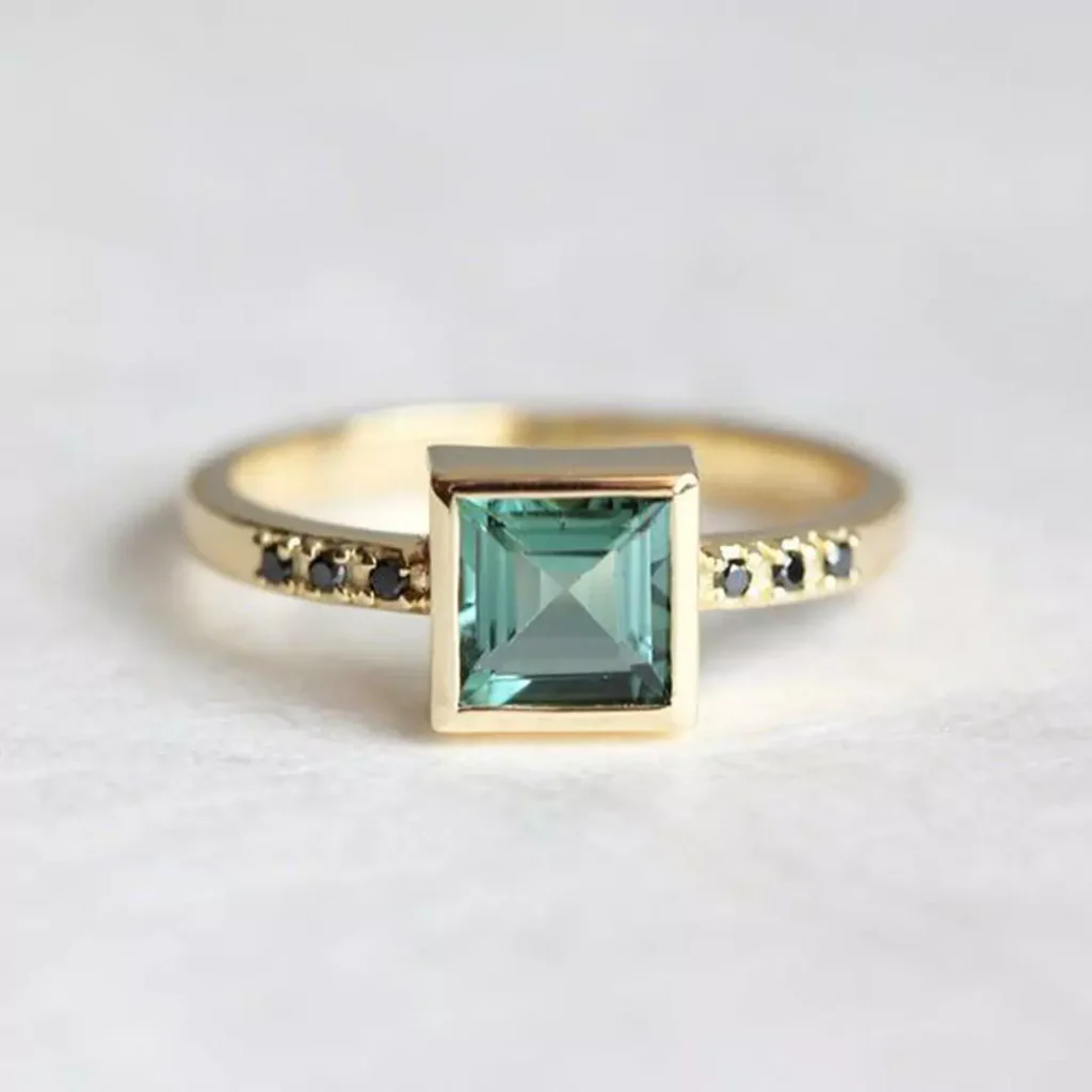 regal gold rings with square green gemstones 